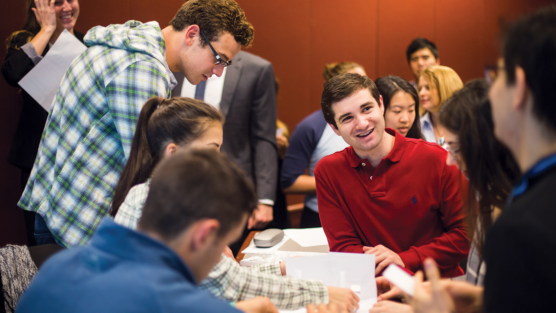 business school students working and talking together