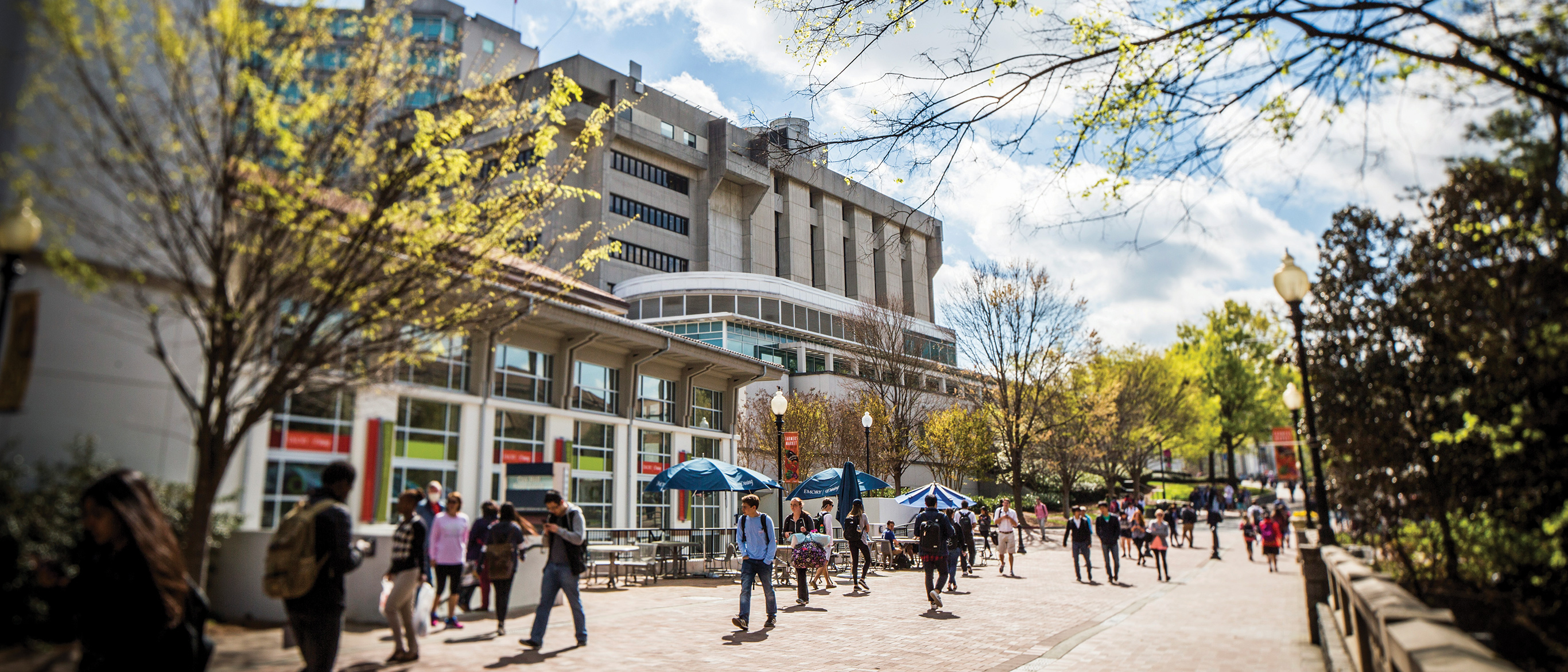 Students strolling along interior Emory Atlanta campus in front of Cox Hall
