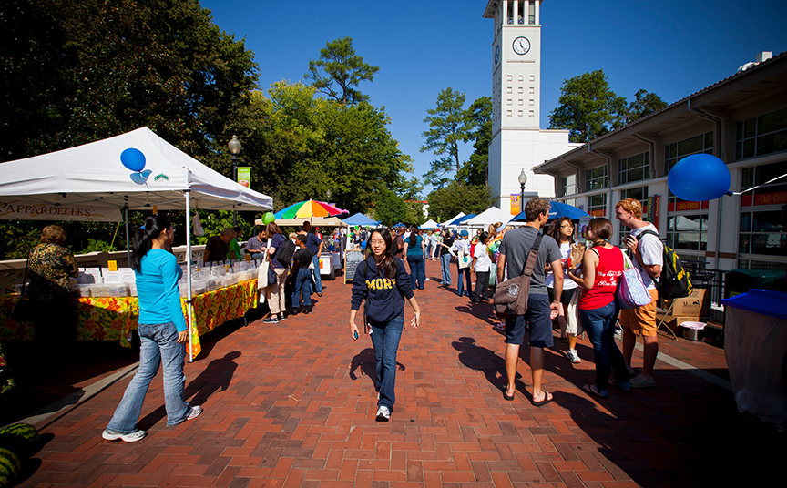 student walking along Asbury Circle bridge during Emory Farmer's Market