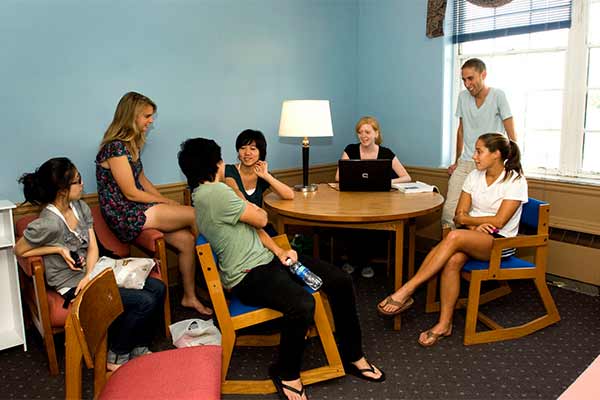 Students sitting around a table and having a conversation