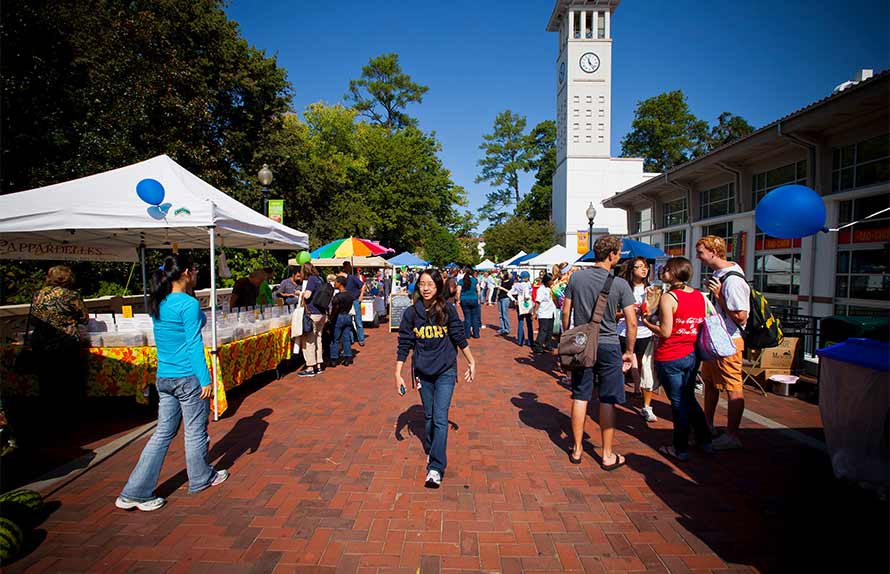 student walking along Asbury Circle bridge during Emory Farmer's Market